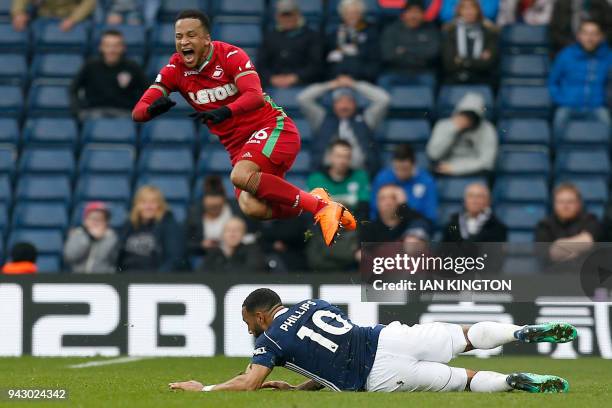 West Bromwich Albion's English-born Scottish midfielder Matt Phillips fouls Swansea City's Swedish defender Martin Olsson during the English Premier...