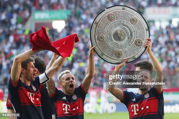 Franck Ribery of Bayern Muenchen and Rafinha of Bayern Muenchen celebrate with a replica of the champions trophy, after Muenchen won the...