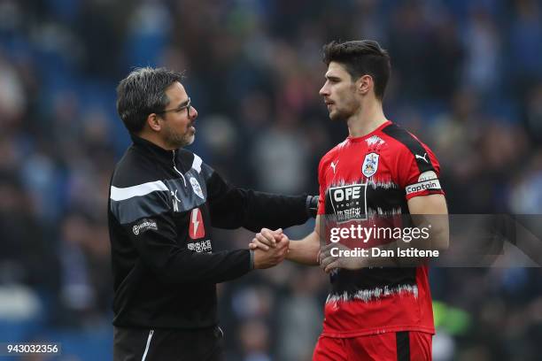David Wagner, Manager of Huddersfield Town speaks with Christopher Schindler of Huddersfield Town after the Premier League match between Brighton and...