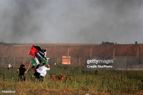 Palestinians protesters during clashes with Israeli toops near the border with Israel in the east of Jabaliya refugee camp in the northern Gaza...