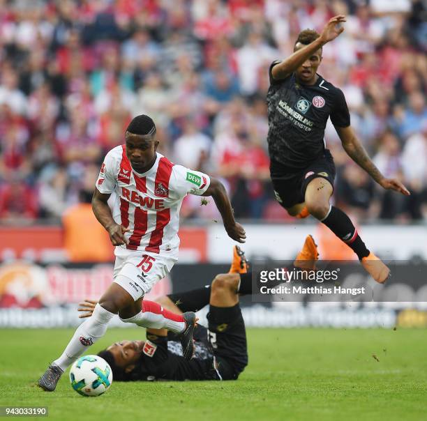 Jhon Cordoba of Koeln fights for the ball with Jean-Philippe Gbamin of Mainz and Karim Onisiwo of Mainz during the Bundesliga match between 1. FC...