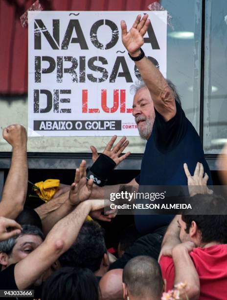 Brazilian ex-president Luiz Inacio Lula da Silva waves to supporters after attending a Catholic Mass in memory of his late wife Marisa Leticia, at...