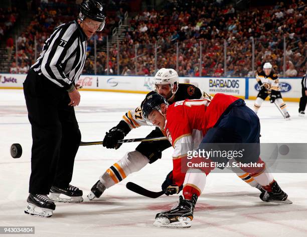 Linesman Tim Nowak drops the puck for a face off between Aleksander Barkov of the Florida Panthers and Patrice Bergeron of the Boston Bruins at the...