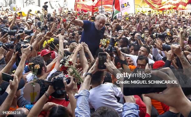 Brazilian ex-president Luiz Inacio Lula da Silva is carried by supporters after attending a Catholic Mass in memory of his late wife Marisa Leticia,...