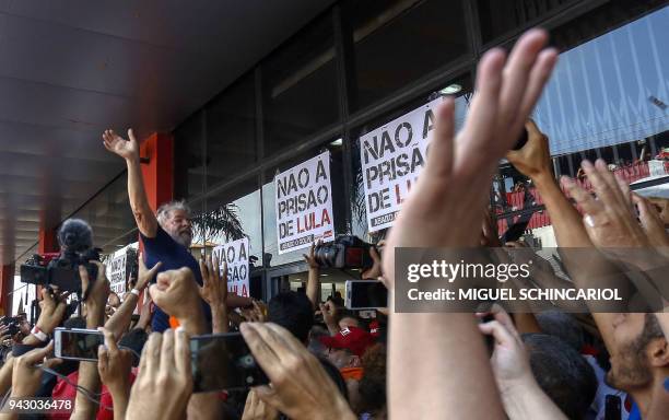 Brazilian ex-president Luiz Inacio Lula da Silva waves to supporters after attending a Catholic Mass in memory of his late wife Marisa Leticia, at...