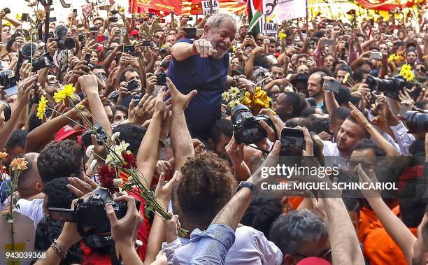 Brazilian ex-president Luiz Inacio Lula da Silva waves to supporters after attending a Catholic Mass in memory of his late wife Marisa Leticia, at...