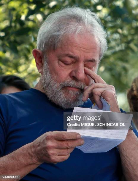 Brazilian ex-president Luiz Inacio Lula da Silva gestures as he reads after attending a Catholic Mass in memory of his late wife Marisa Leticia, at...