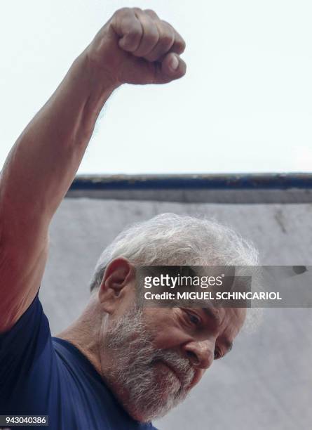 Brazilian ex-president Luiz Inacio Lula da Silva raises his fist after a Catholic Mass in memory of his late wife Marisa Leticia, at the...
