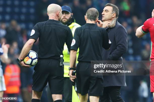 Swansea City manager Carlos Carvalhal talks with Referee Roger East after the final whistle of the Premier League match between Swansea City and West...