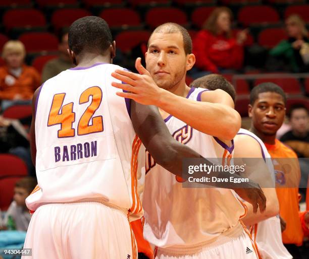 Earl Barron of the Iowa Energy gives teammate Taylor Griffin, on assignment from the Phoenix Suns, a hug as they take the court against the Dakota...