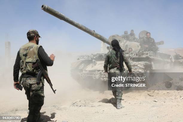 Pro Syrian regime forces are seen as they advance towards the town of Douma, the last opposition holdout in Eastern Ghouta, on April 7 after regime...