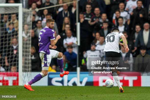 Derby County's Tom Lawrence scoring his side's third goal under pressure from Bolton Wanderers' Mark Beevers during the Sky Bet Championship match...