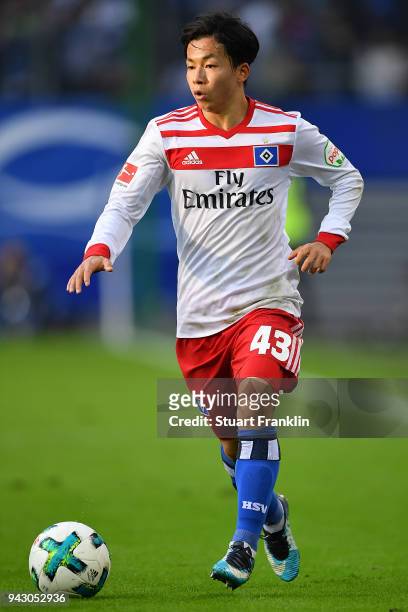 Tatsuya Ito of Hamburg runs with ball during the Bundesliga match between Hamburger SV and FC Schalke 04 at Volksparkstadion on April 7, 2018 in...