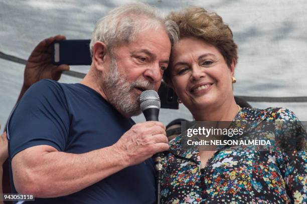 Brazilian ex-president Luiz Inacio Lula da Silva speaks next to Brazilian former president Dilma Rousseff during a Catholic mass in memory of Lula's...