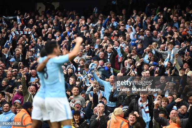 Manchester City fans celebrate their sides second goal during the Premier League match between Manchester City and Manchester United at Etihad...
