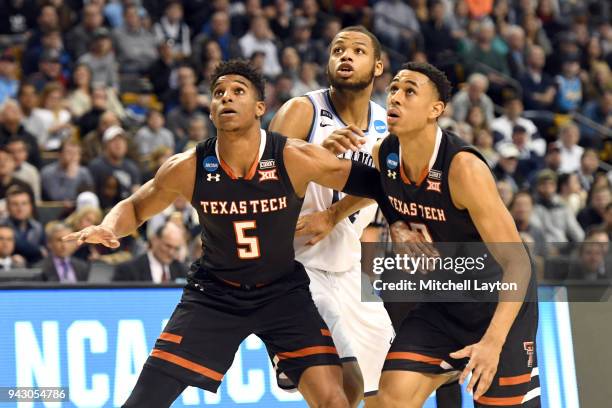 Justin Gray and Zhaire Smith of the Texas Tech Red Raiders protect the lane from Omari Spellman of the Villanova Wildcats during the 2018 NCAA Men's...