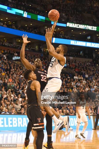 Mikal Bridges of the Villanova Wildcats takes a shot over Norense Odiase and Justin Gray of the Texas Tech Red Raiders during the 2018 NCAA Men's...