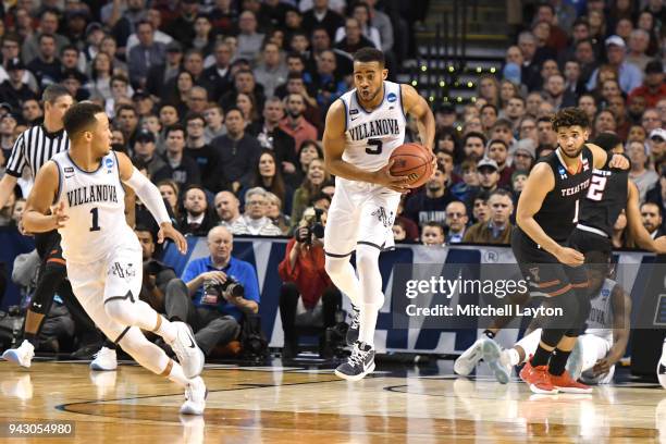 Phil Booth of the Villanova Wildcats grabs a loose ball during the 2018 NCAA Men's Basketball Tournament East Regional against the Texas Tech Red...