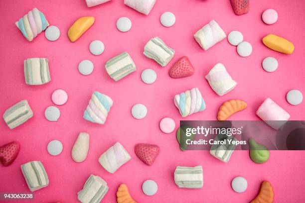 asorment of candies and sweets in pink background - marsh mallows stock pictures, royalty-free photos & images
