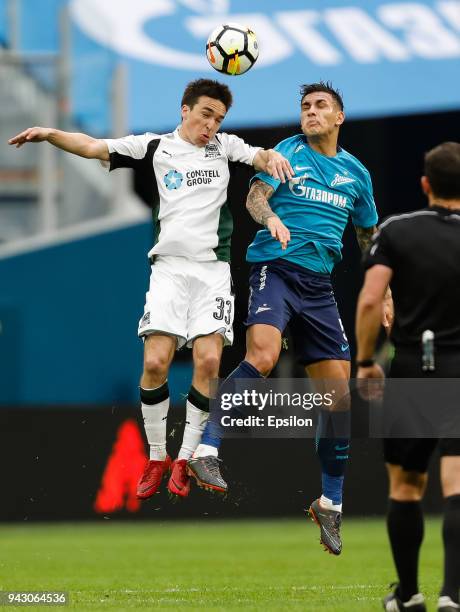 Leandro Paredes of FC Zenit Saint Petersburg and Mauricio Pereyra of FC Krasnodar vie for a header during the Russian Football League match between...