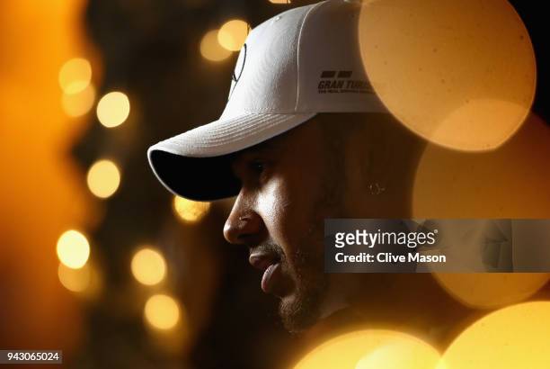Lewis Hamilton of Great Britain and Mercedes GP talks to the media in the Paddock after qualifying for the Bahrain Formula One Grand Prix at Bahrain...