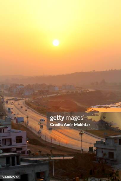 cityscape at sunset with road and river in the background - punjab aerial view stock pictures, royalty-free photos & images