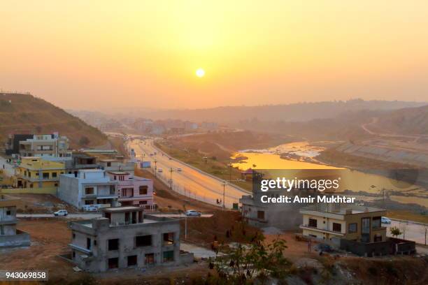 cityscape at sunset with road and river in the background - punjab aerial view stock pictures, royalty-free photos & images