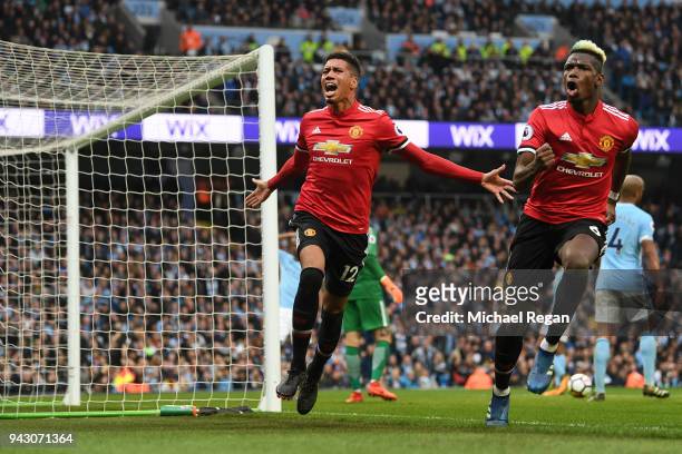 Chris Smalling of Manchester United celebrates scoring his side's third goal with Paul Pogba during the Premier League match between Manchester City...