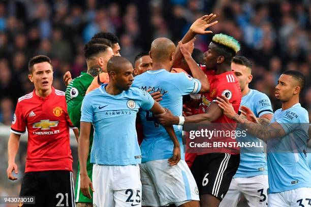 Manchester United's French midfielder Paul Pogba clashes with Manchester City players after a foul on Manchester United's English midfielder Jesse...