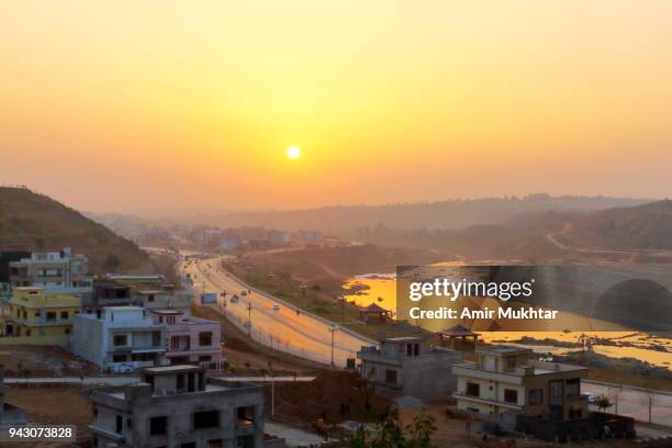 cityscape at sunset with road and river in the background - punjab aerial view stock pictures, royalty-free photos & images