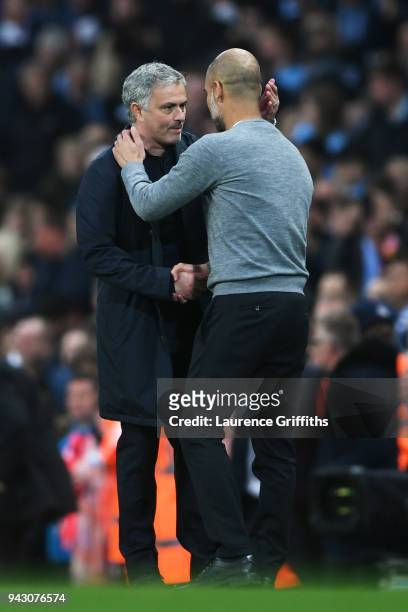 Josep Guardiola, Manager of Manchester City and Jose Mourinho, Manager of Manchester United embrace following the Premier League match between...