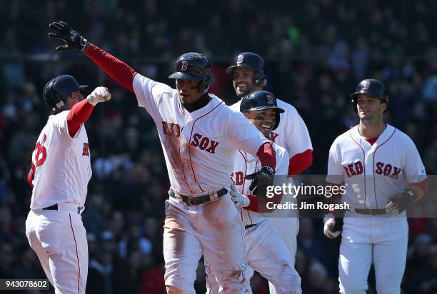 Xander Bogaerts of the Boston Red Sox celebrates with Mookie Betts, Andrew Benintendi and J.D. Martinez after his grand slam home run against the...