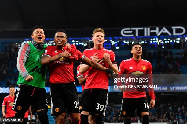 Manchester United's Argentinian defender Marcos Rojo, Manchester United's Ecuadorian midfielder Antonio Valencia, Manchester United's midfielder...