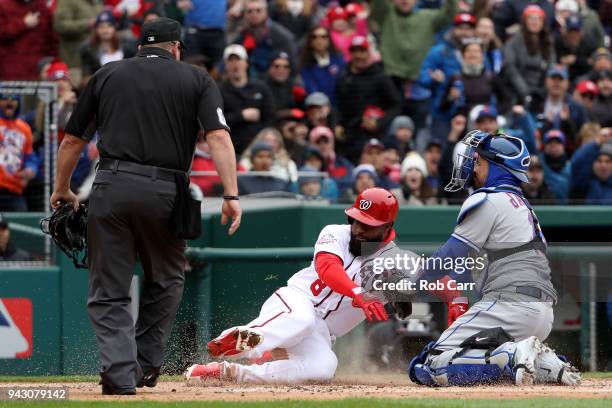 Home plate umpire Marty Foster looks on as Brian Goodwin of the Washington Nationals is tagged out at home plate by catcher Travis d'Arnaud of the...