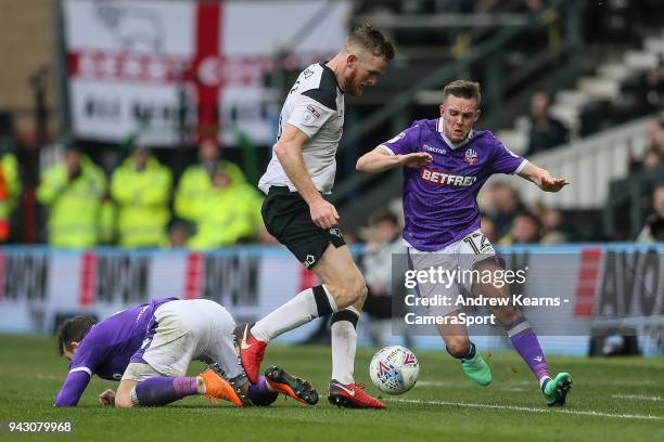 Bolton Wanderers' Craig Noone competing with Derby County's Alex Pearce during the Sky Bet Championship match between Derby County and Bolton...