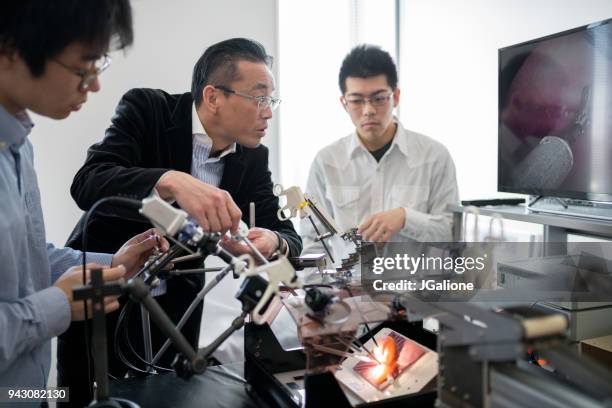 engineering students and professor working together - japan technology stock pictures, royalty-free photos & images