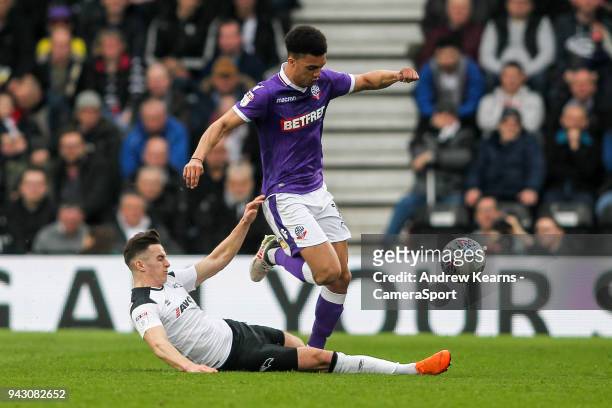Bolton Wanderers' Antonee Robinson competing with Derby County's Tom Lawrence during the Sky Bet Championship match between Derby County and Bolton...