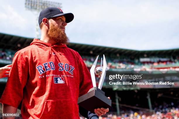 Craig Kimbrel of the Boston Red Sox is presented with the 2017 Reliever of the Year award before a game against the Tampa Bay Rays on April 7, 2018...