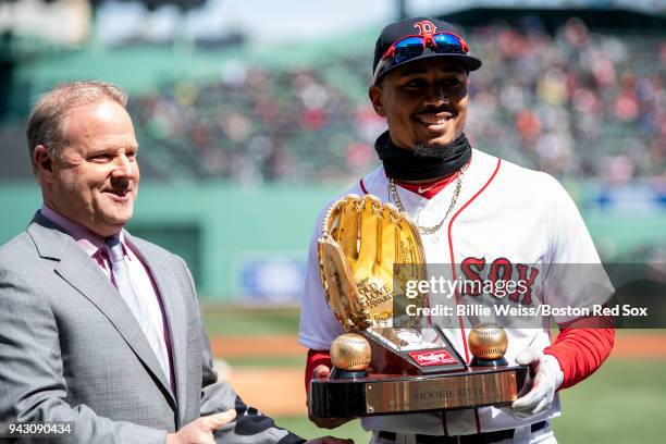 Mookie Betts of the Boston Red Sox is presented with the 2017 Gold Glove award before a game against the Tampa Bay Rays on April 7, 2018 at Fenway...
