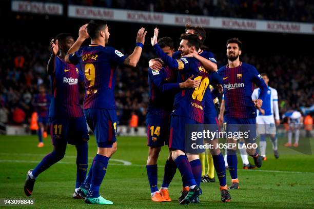 Barcelona's Argentinian forward Lionel Messi celebrates with teammates after scoring a goal during the Spanish league football match between...