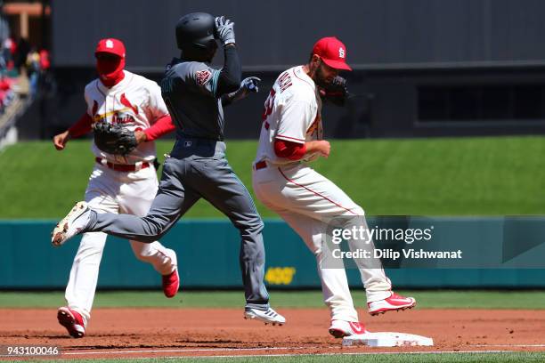 Michael Wacha of the St. Louis Cardinals beats Jarrod Dyson of the Arizona Diamondbacks to first base for an out in the first inning at Busch Stadium...