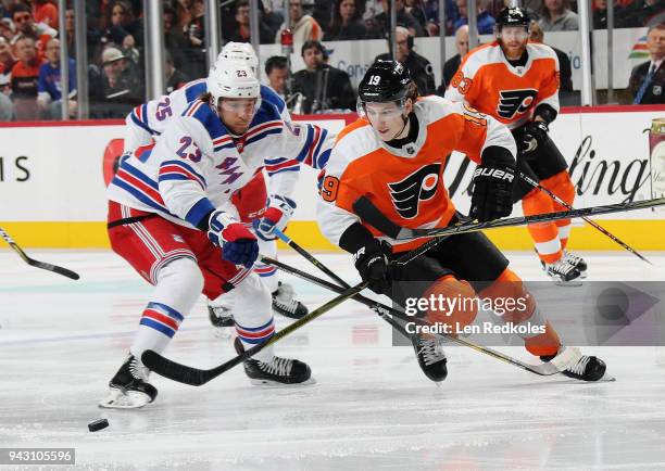 Nolan Patrick of the Philadelphia Flyers battles for the loose puck with Ryan Spooner of the New York Rangers on April 7, 2018 at the Wells Fargo...