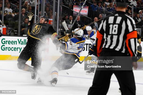 Vegas Golden Knights defenceman Colin Miller and St. Louis Blues center Oskar Sundqvist collide while going for the puck during the game between the...