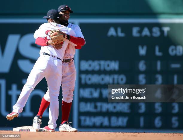 Xander Bogaerts of the Boston Red Sox celebrates with Eduardo Nunez after defeating the Tampa Bay Rays 10-3 at Fenway Park, on April 7 in Boston,...