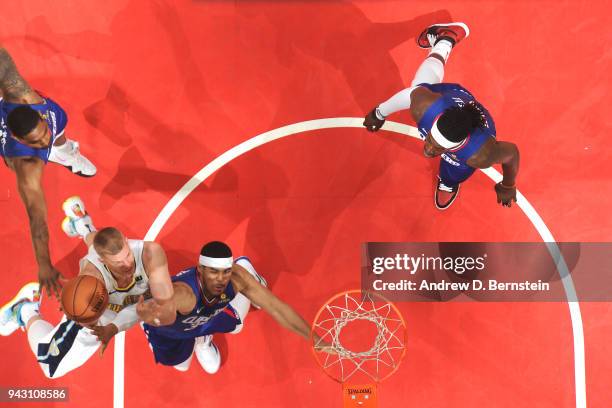 Mason Plumlee of the Denver Nuggets dunks against Tobias Harris of the LA Clippers on April 7, 2018 at STAPLES Center in Los Angeles, California....