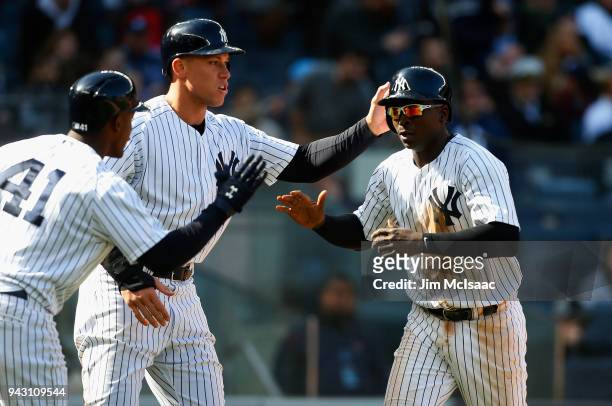 Didi Gregorius and Aaron Judge of the New York Yankees celebrate with teammate Miguel Andujar after both scored in the seventh inning against the...