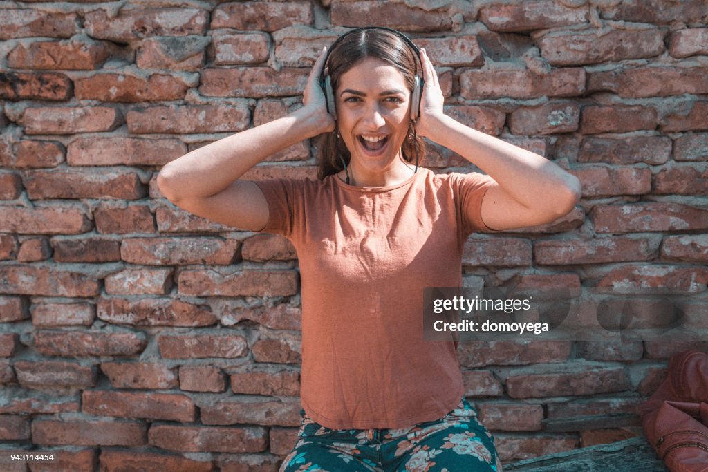Young woman listening to music outdoors on a sunny day