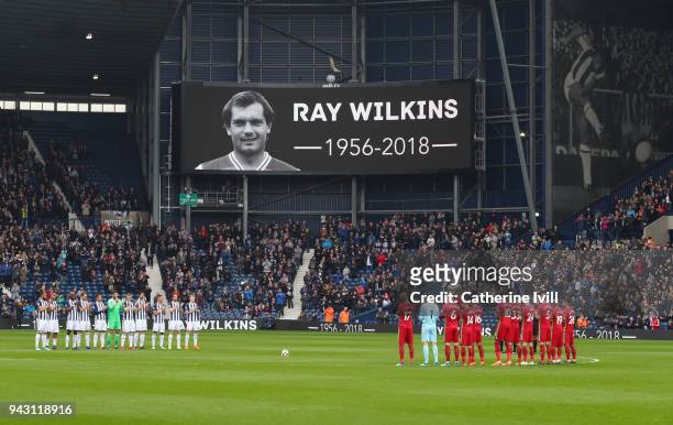 Fans, officials and players take part in a minute of applause for Ray Wilkins who passed away earlier in the week, an image of Cyril Regis who passed...