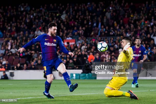 Lionel Messi of FC Barcelona shoots the ball over goalkeeper Ivan Cuellar of CD Leganes and scores his team's third goal during the La Liga match...