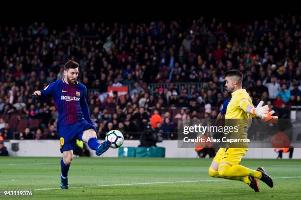 Lionel Messi of FC Barcelona shoots the ball over goalkeeper Ivan Cuellar of CD Leganes and scores his team's third goal during the La Liga match...